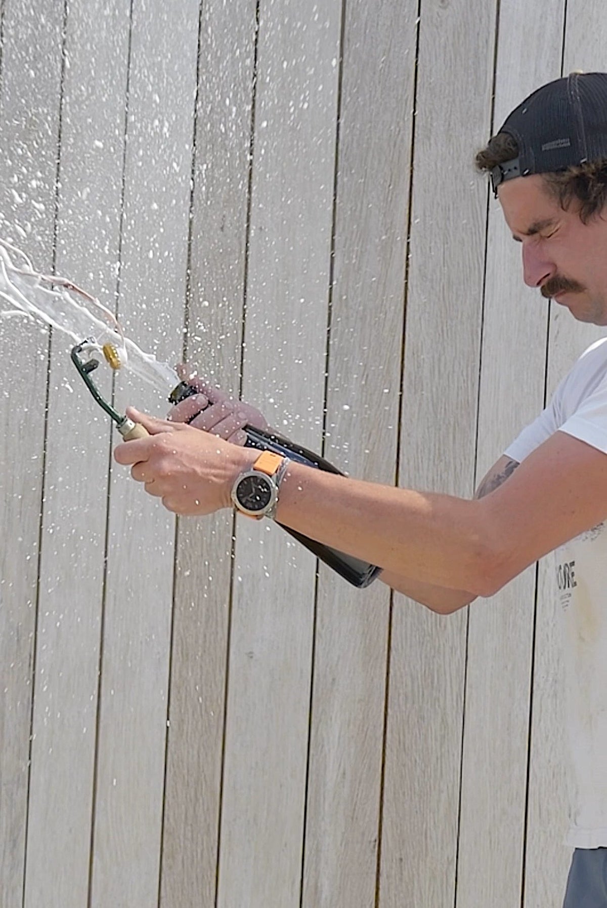 A grower hand-disgorging a bottle of Champagne Petit Clergeot, the frozen plug firing out in a spray
